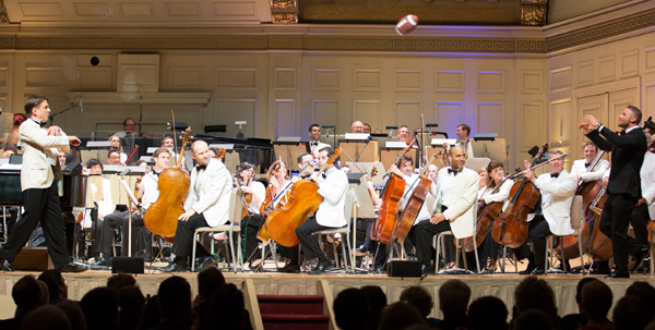 Keith Lockhart throws football to Julian Edelman at The Boston Pops